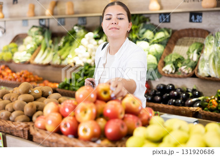 Portrait of happy female customer selecting fruits in grocery store 131920686