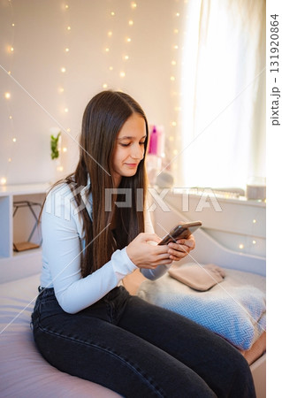 Teenager using phone texting on social media at home 131920864