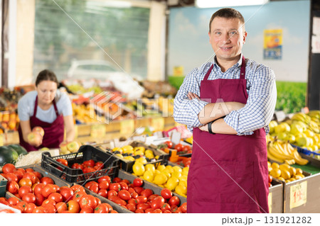 Portrait of an smiling supermarket worker in sales floor Portrait of an smiling supermarket worker in sales floor 131921282