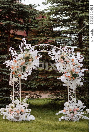 Wedding floral arch with white and pink flowers in garden at sunset 131921461