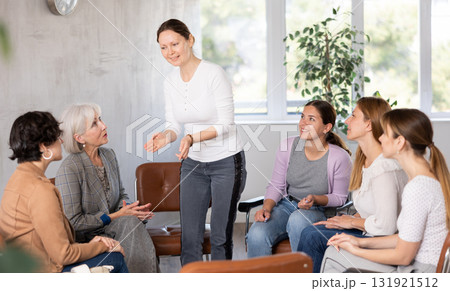 Female teacher giving lecture to group of students in classroom Female teacher giving lecture to group of students in classroom 131921512