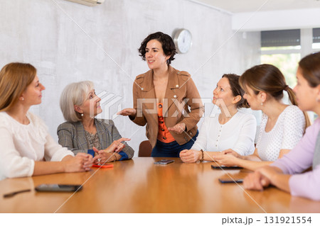 Female speaker giving presentation for cheerful positive smiling students in lecture hall Female speaker giving presentation for cheerful positive smiling students in lecture hall 131921554