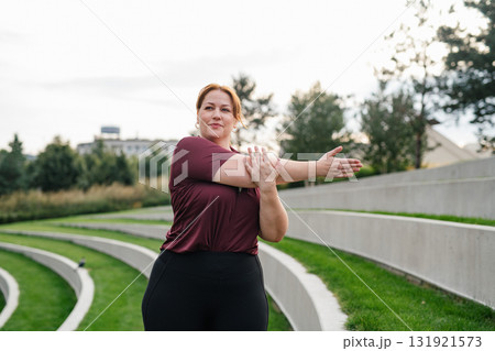 Body positive woman warming up before training. Body positive woman warming up before training. 131921573
