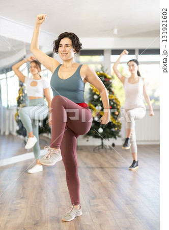Slender young women dancers dance a twist in a modern way during Christmas celebration Slender young women dancers dance a twist in a modern way during Christmas celebration 131921602