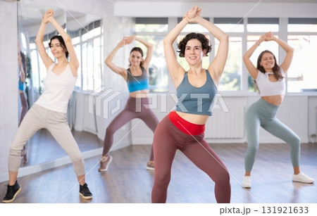 Female teacher conducts modern dance lessons for group of girls 131921633