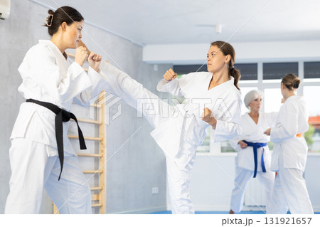 Two young women training karate techniques 131921657