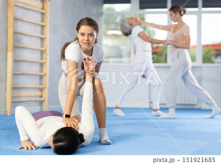 Woman learns to make power grab against female attacker under guidance of trainer. Self-defense class 131921685
