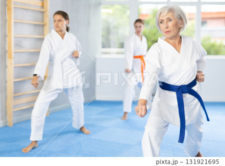 Athletes have starting position and repeating sequence of punches and painful techniques in kata Athletes have starting position and repeating sequence of punches and painful techniques in kata 131921695