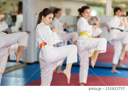 Female athletes standing in formation, kata starting position Female athletes standing in formation, kata starting position 131921757