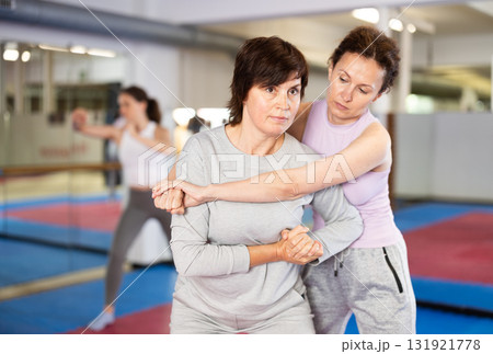 Women practice self-defense techniques in pairs Women practice self-defense techniques in pairs 131921778