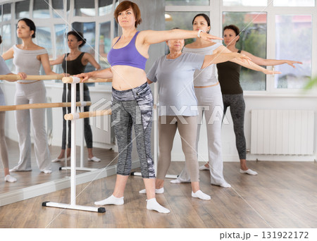 Group of women stand in second position at barre Group of women stand in second position at barre 131922172