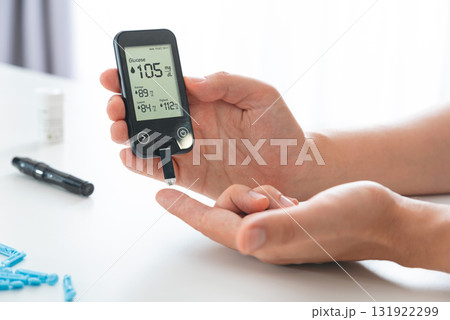 Patient checking blood sugar level with glucometer Patient checking blood sugar level with glucometer 131922299