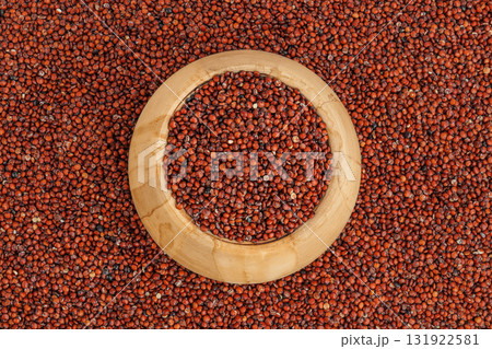 red quinoa seeds in wooden bowl as a background. Top view. Flat lay red quinoa seeds in wooden bowl as a background. Top view. Flat lay 131922581