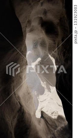 3D rendering. Light at the end of the tunnel through the rock. A cave in the mountain with an exit at the end. 131923083