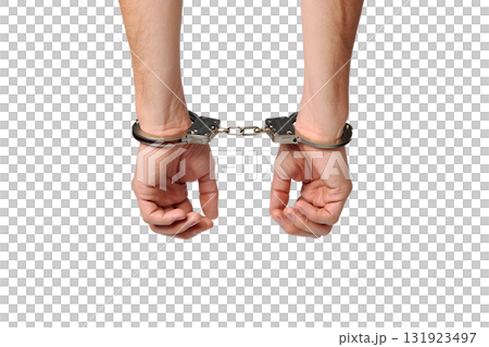 Person's hands bound in cold, hard handcuffs, isolated on transparent background for legal, crime, or protest concepts 131923497