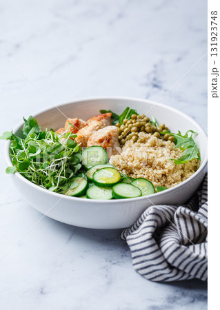 Balanced quinoa, arugula, chicken, cucumber and pea lunch bowl. 131923748