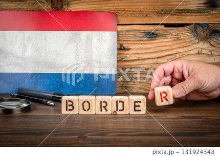 Wooden blocks spelling BORDER in front of Netherlands flag Wooden blocks spelling BORDER in front of Netherlands flag 131924348