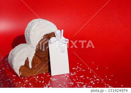 White paper note mockup template greeting holiday card Heart shaped coconut flavor croissant on red background with copy space. Puff pastry new trendy sweet dessert bakery. Creamy dough White paper note mockup template greeting holiday card Heart shaped coconut flavor croissant on red background with copy space. Puff pastry new trendy sweet dessert bakery. Creamy dough 131924974