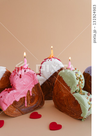 Holiday birthday anniversary shiny candle sparkler on cake Delightful and vibrant heartshaped pastry croissant treat, beautifully topped with colorful frosting galore. Food experimentation dessert Holiday birthday anniversary shiny candle sparkler on cake Delightful and vibrant heartshaped pastry croissant treat, beautifully topped with colorful frosting galore. Food experimentation dessert 131924983