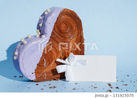 Empty paper note card template mock up Heart shaped blueberry flavor croissant on blue background with copy space. Puff pastry new trendy sweet dessert bakery. Creamy dough Empty paper note card template mock up Heart shaped blueberry flavor croissant on blue background with copy space. Puff pastry new trendy sweet dessert bakery. Creamy dough 131925070