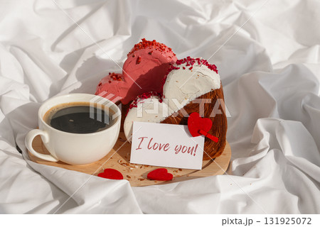 I LOVE YOU text message paper note card Morning breakfast Valentine's Day Birthday celebration Delicious fresh variety croissants topped with colorful flavor Ganache. Creation unique heart shape 131925072