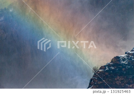 Close-up of a rainbow spanning Victoria Falls 131925463