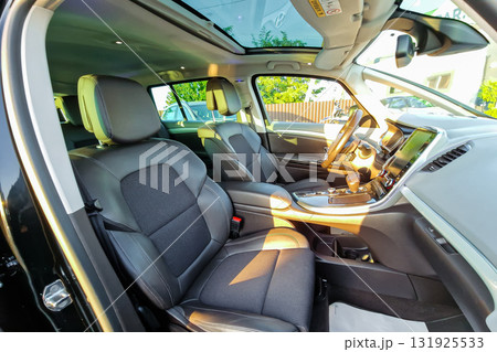Interior view of a modern SUV showcasing spacious design and luxury features, highlighting comfort and technology on a sunny day in a suburban area Interior view of a modern SUV showcasing spacious design and luxury features, highlighting comfort and technology on a sunny day in a suburban area 131925533