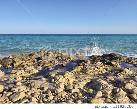 The idyllic and tranquil coastal view features serene blue waters stretching to the horizon 131926260