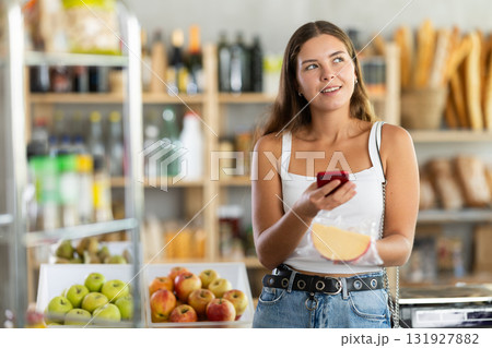 Young woman scanning qr code of cheese Young woman scanning qr code of cheese 131927882