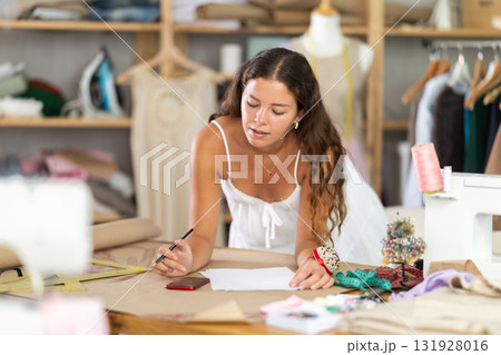 Woman working with documents and counting on mobile 131928016