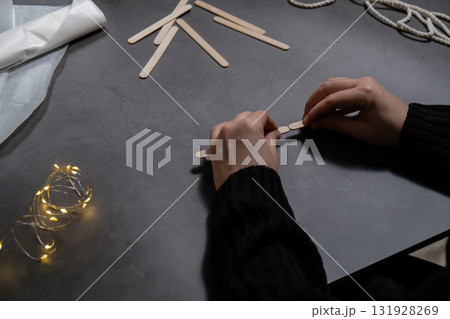 Ice cream sticks Christmas tree Sustainable preparation Diy process making handmade decoration. Step by step activity for children. Inclusive and responsible stress relief holiday hobby 131928269