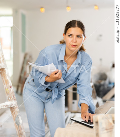 Woman designer using laptop in construction site 131928277