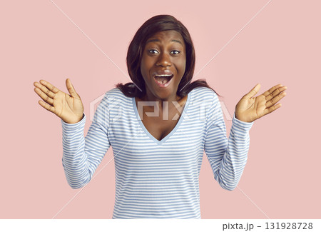 Portrait of African American woman looking at camera with happy, surprised expression 131928728