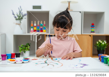 happy toddler girl painting watercolor in paper at home happy toddler girl painting watercolor in paper at home 131929084