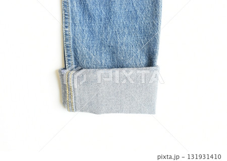 roll up sleeve of blue denim shirt texture isolated on white background, jean fashion style 131931410