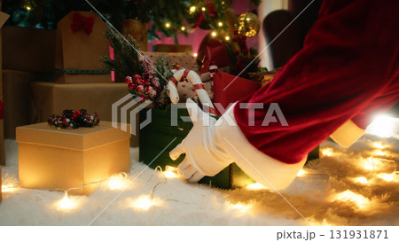 Santa Claus places basket full of gifts 131931871
