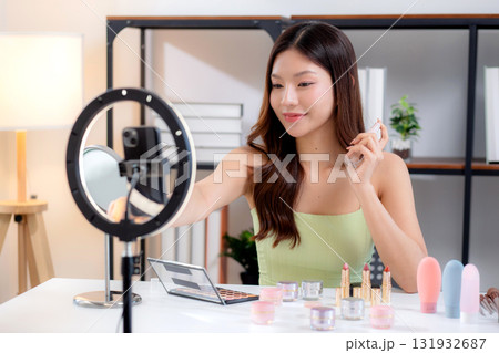 Young asian woman facial spray or serum on social media, content creator. Young asian woman facial spray or serum on social media, content creator. 131932687