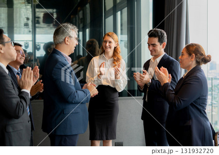Happy group business team clapping and celebrating success or achievement in office. 131932720