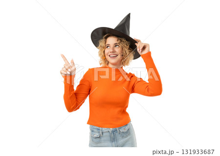 Young woman in orange sweater, witch hat, isolated on white, PNG 131933687