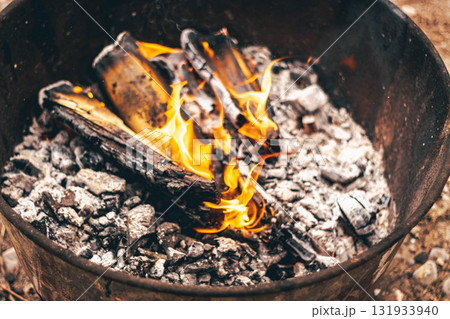 Burning wood and embers for outdoor cooking close-up of fire and ashes 131933940