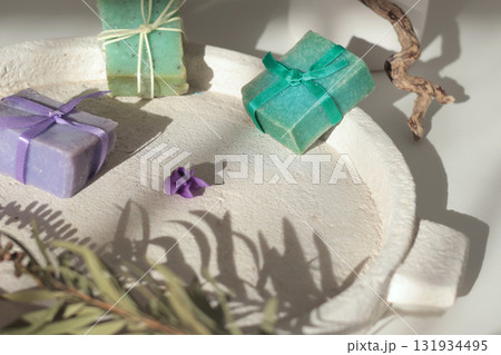 Cubes of natural soap against backdrop of natural elements. Handicrafts and hobbies. Cosmetics and beauty. Eco-friendly products. Background, composition for design. Cubes of natural soap against backdrop of natural elements. Handicrafts and hobbies. Cosmetics and beauty. Eco-friendly products. Background, composition for design. 131934495