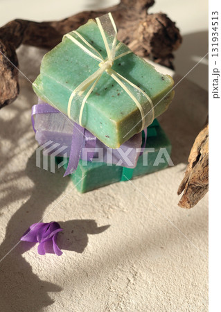 Cubes of natural soap against backdrop of natural elements. Handicrafts and hobbies. Cosmetics and beauty. Eco-friendly products. Background, composition for design. Cubes of natural soap against backdrop of natural elements. Handicrafts and hobbies. Cosmetics and beauty. Eco-friendly products. Background, composition for design. 131934513