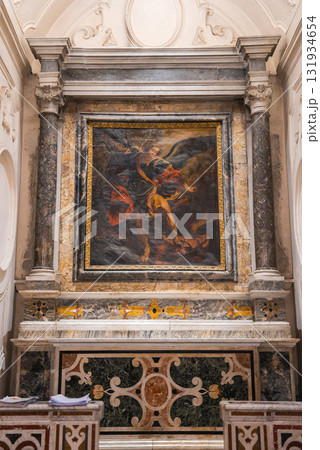 An ornate altar in an Amalfi church features a vivid religious painting framed by marble columns, intricate stonework, and colorful inlays. An ornate altar in an Amalfi church features a vivid religious painting framed by marble columns, intricate stonework, and colorful inlays. 131934654