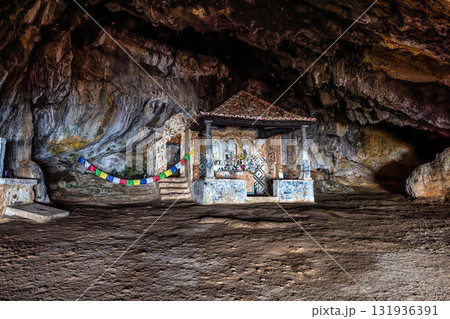 Dark interior of Lapa de Santa Margarida in Arrabida, Setubal, Portugal. Cave with small chapel of spontaneous worship Dark interior of Lapa de Santa Margarida in Arrabida, Setubal, Portugal. Cave with small chapel of spontaneous worship 131936391