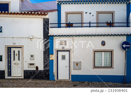 Traditional white houses with blue stripes in the streets of Ericeira in Portugal Traditional white houses with blue stripes in the streets of Ericeira in Portugal 131936401