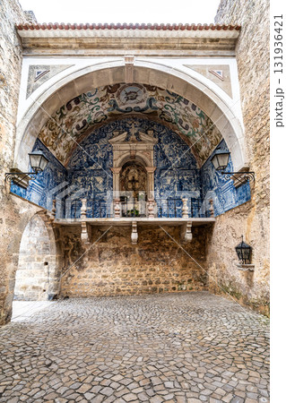 Porta da Vila is the main entrance to Obidos, Portugal. Double door with balcony. Inside azulejos Porta da Vila is the main entrance to Obidos, Portugal. Double door with balcony. Inside azulejos 131936421