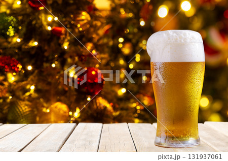 glass of beer on wooden table on festive background 131937061