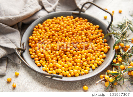 Sea buckthorn berries in bowl with branches, healthy superfood Sea buckthorn berries in bowl with branches, healthy superfood 131937307