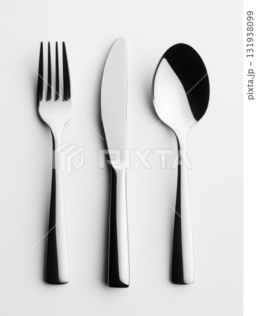 Elegant cutlery arrangement showcasing a fork, knife, and spoon on a neutral background for dining settings 131938099