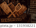 wooden reserved signs designed as cooking utensils in cozy restaurant during evening hours. closeup. 131938221